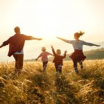 Happy family: mother, father, children son and  daughter on nature  on sunset